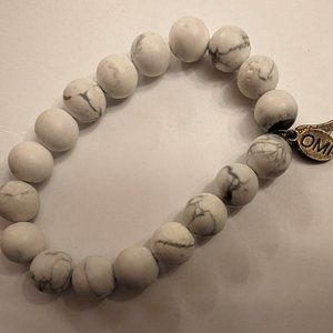 Omi bracelet with semi-precious stones and feather charm.